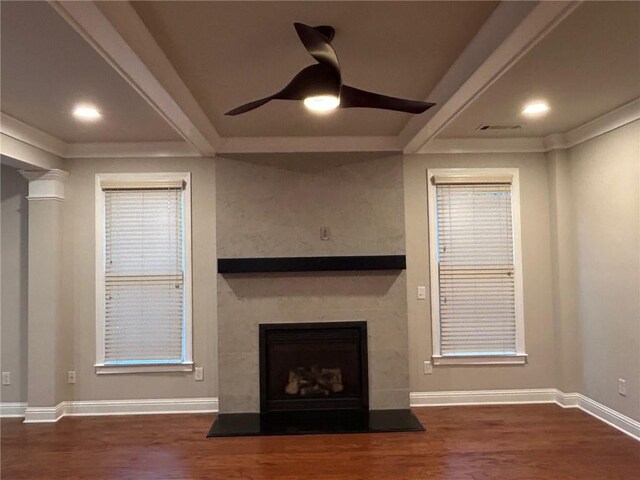 unfurnished living room with dark hardwood / wood-style flooring and ceiling fan