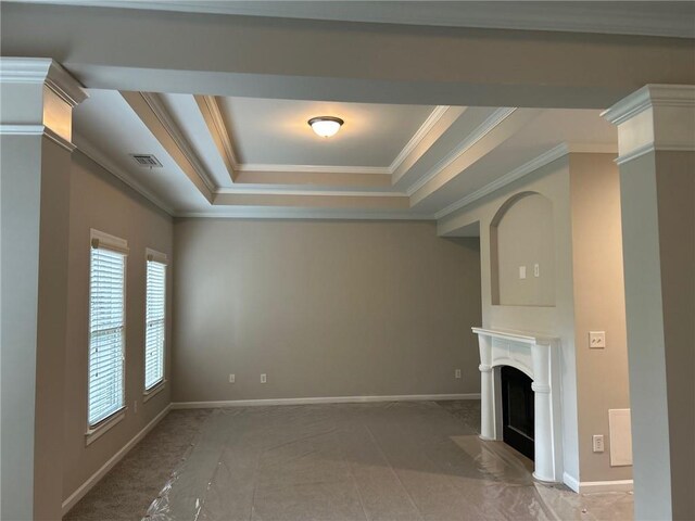 unfurnished living room with a raised ceiling, carpet floors, and crown molding