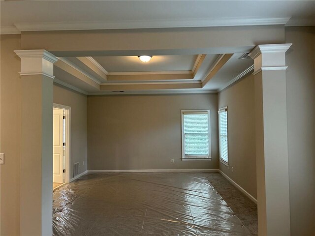 unfurnished room featuring ornate columns, a raised ceiling, and crown molding