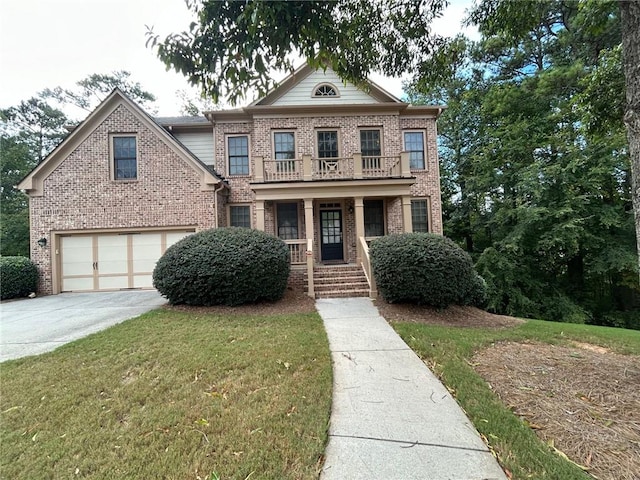 view of front of house featuring a front yard, a garage, and covered porch