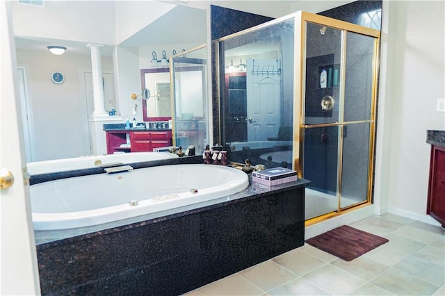 bathroom featuring vanity, a garden tub, decorative columns, and a stall shower