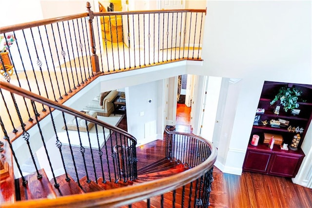 stairway featuring wood finished floors and baseboards