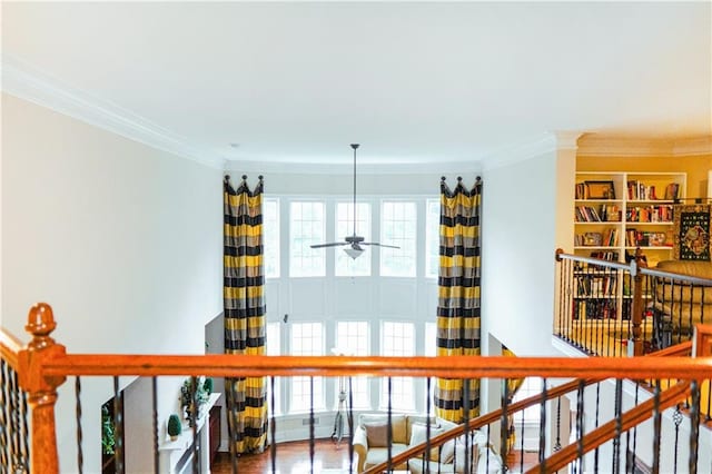 staircase featuring crown molding, wood finished floors, and a ceiling fan