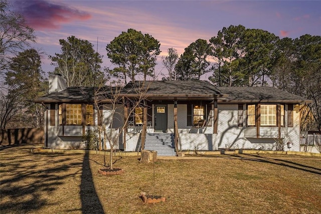 ranch-style home with a yard