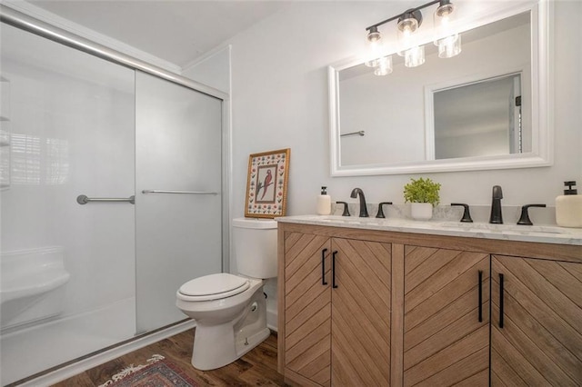 bathroom featuring vanity, toilet, an enclosed shower, and wood-type flooring