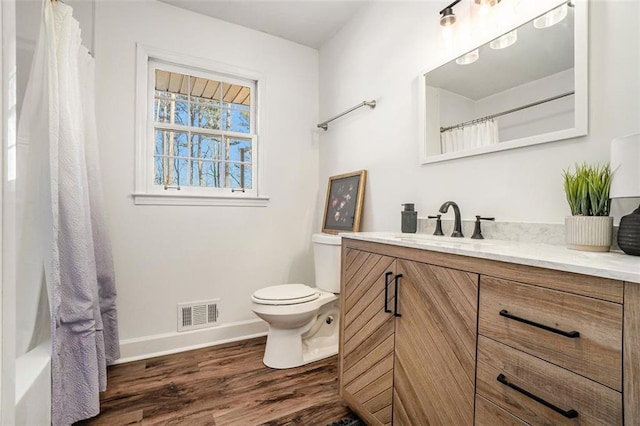 bathroom featuring hardwood / wood-style floors, toilet, and vanity