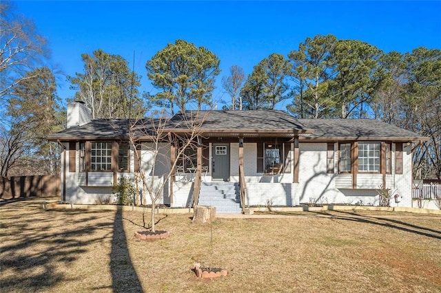 ranch-style home with covered porch and a front yard