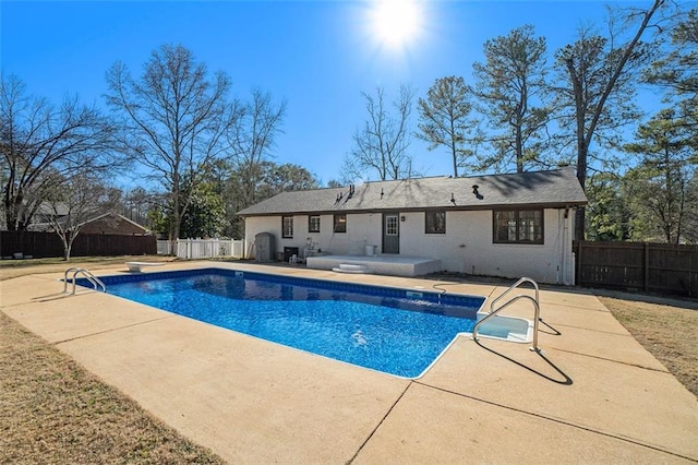 view of pool featuring a diving board and a patio