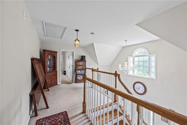 38 Olde Wick Trl, Hoschton, GA 30548 - hallway featuring attic access, an upstairs landing, light colored carpet, and a chandelier