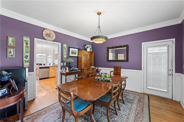 38 Olde Wick Trl, Hoschton, GA 30548 - dining area with light wood-style floors, crown molding, a wainscoted wall, and a chandelier