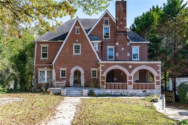 1225 Clifton Rd, Atlanta, GA 30307 - tudor house featuring covered porch and a front yard