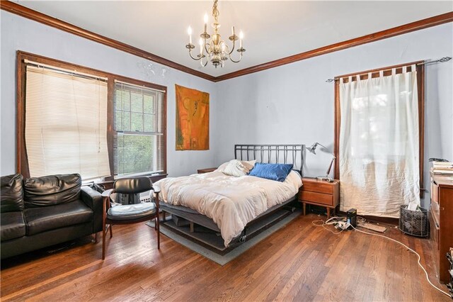 1225 Clifton Rd, Atlanta, GA 30307 - bedroom featuring hardwood / wood-style floors, ornamental molding, and an inviting chandelier