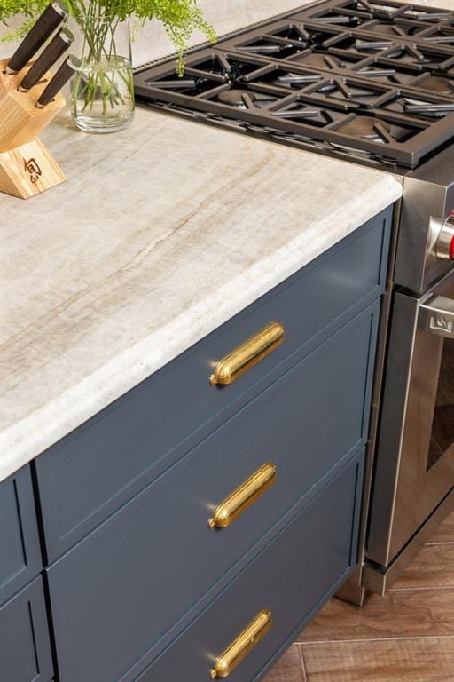 interior details with light countertops and blue cabinetry