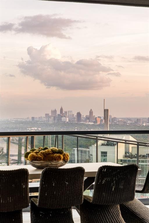 balcony at dusk featuring a city view