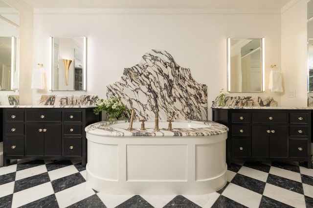 bathroom featuring tile patterned floors, a bath, and two vanities