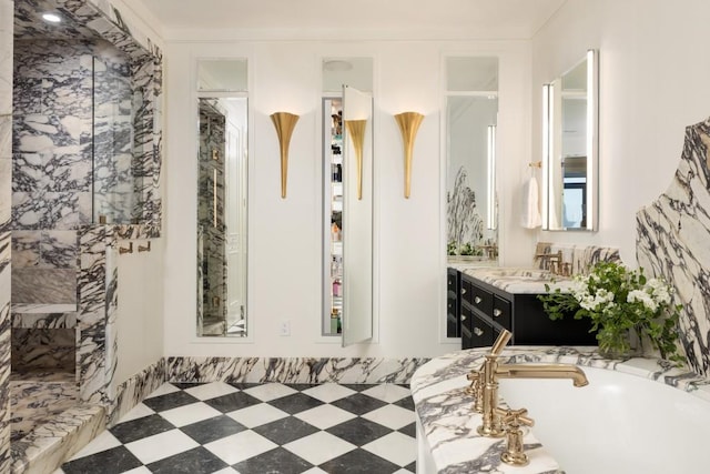 bathroom featuring a freestanding bath and vanity
