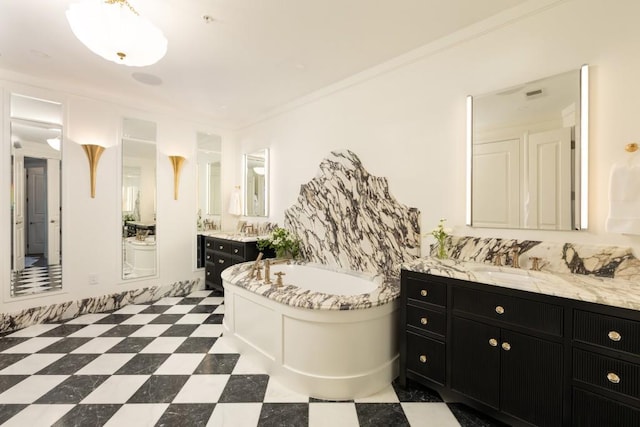 bathroom featuring two vanities, a sink, and a garden tub