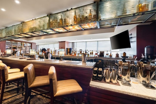 bar featuring recessed lighting and a bar
