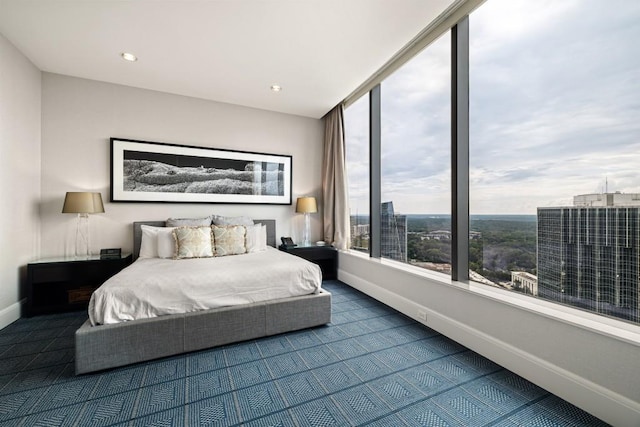 bedroom with recessed lighting, baseboards, and dark carpet