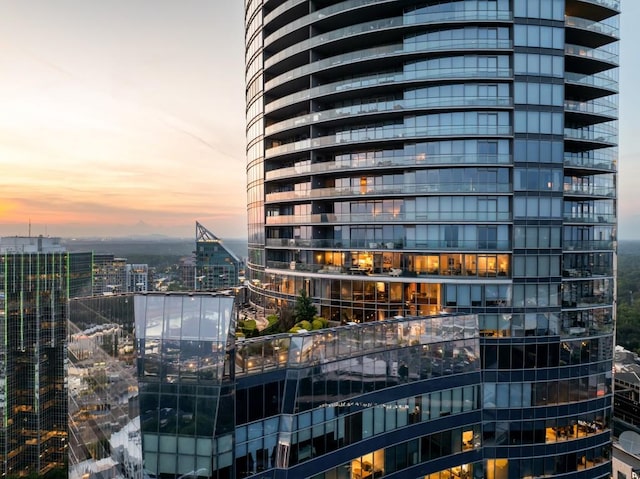 property at dusk with a city view