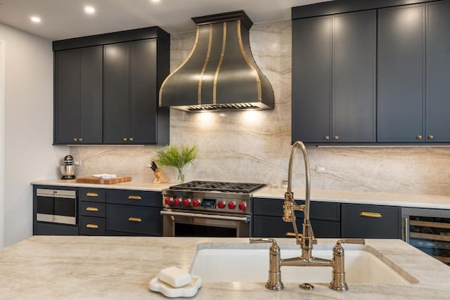 kitchen featuring wall chimney range hood, beverage cooler, high end stainless steel range, and light countertops
