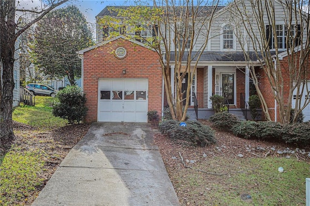 front of property featuring covered porch and a garage