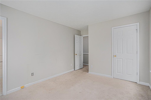 unfurnished bedroom featuring light colored carpet