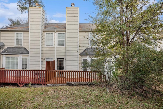 rear view of property featuring a deck