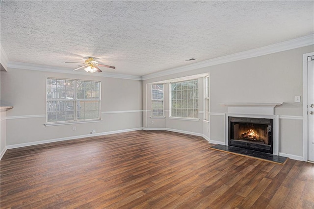 unfurnished living room with a textured ceiling, dark hardwood / wood-style floors, ceiling fan, and ornamental molding