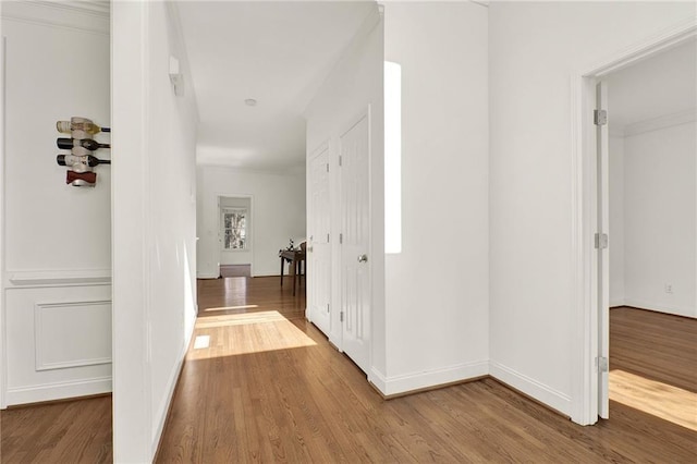 hall with hardwood / wood-style floors
