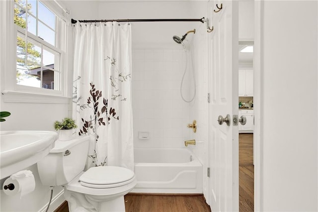 bathroom with shower / bath combo, wood-type flooring, and toilet