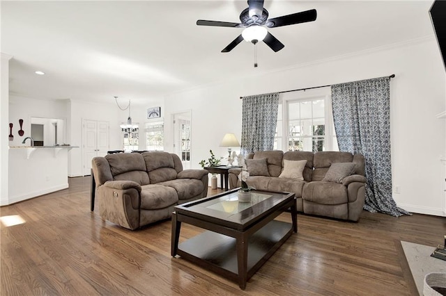 living room with hardwood / wood-style floors, crown molding, and ceiling fan