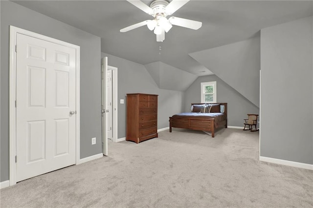 bedroom featuring lofted ceiling, light colored carpet, and ceiling fan
