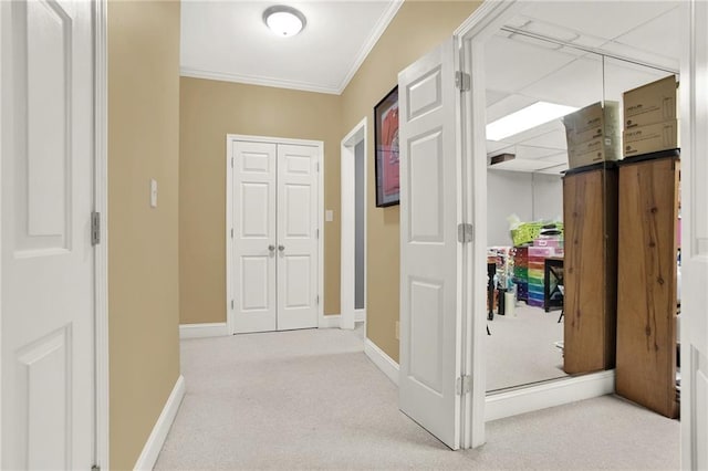 hallway featuring crown molding and light colored carpet