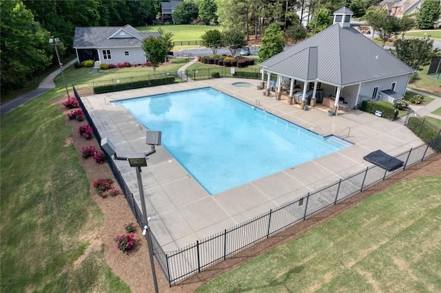 view of swimming pool with a hot tub, a patio, and a lawn