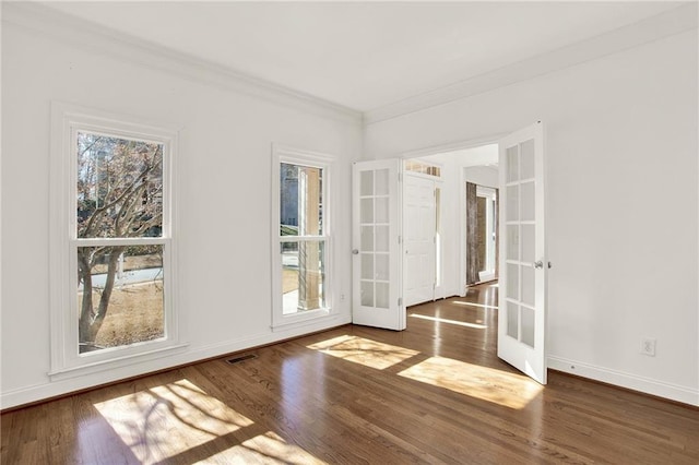 unfurnished room with french doors, crown molding, and dark hardwood / wood-style floors