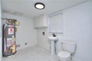 bathroom featuring water heater and toilet