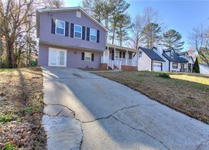 split level home featuring concrete driveway