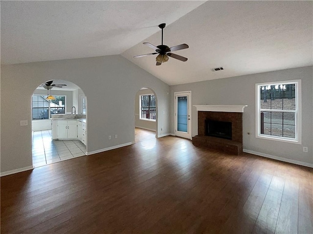 unfurnished living room featuring ceiling fan and a wealth of natural light