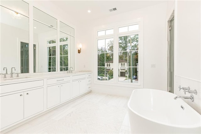 bathroom with a bathtub, wood-type flooring, and vanity