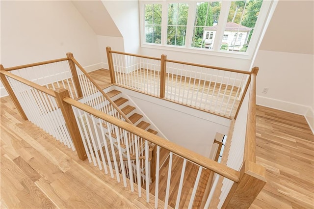 stairs with hardwood / wood-style flooring