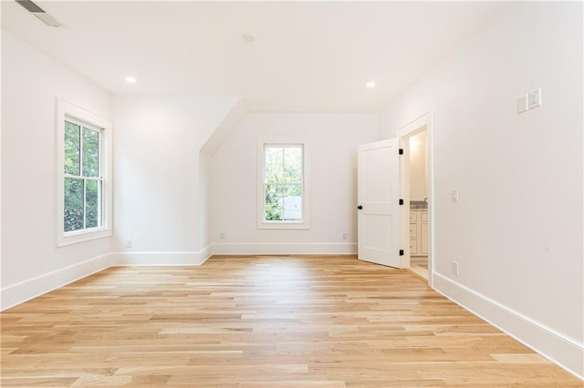 additional living space with light hardwood / wood-style floors and a wealth of natural light