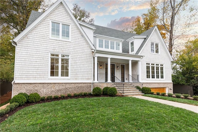 view of front of house with covered porch and a lawn