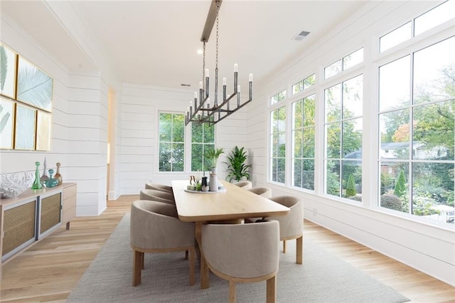 sunroom featuring an inviting chandelier