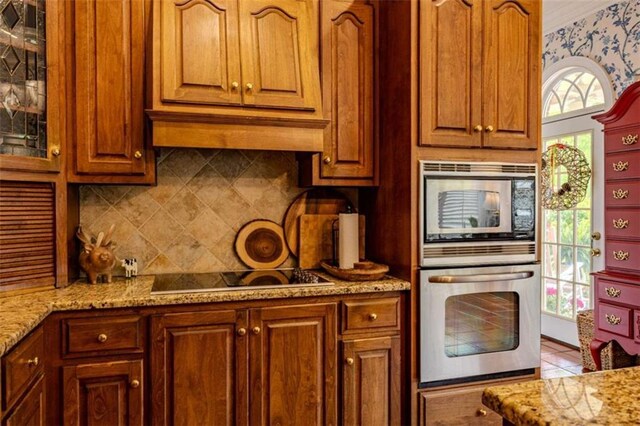 7174 Rockmart Rd, Silver Creek, GA 30173 - kitchen featuring tasteful backsplash, light stone counters, glass insert cabinets, and appliances with stainless steel finishes