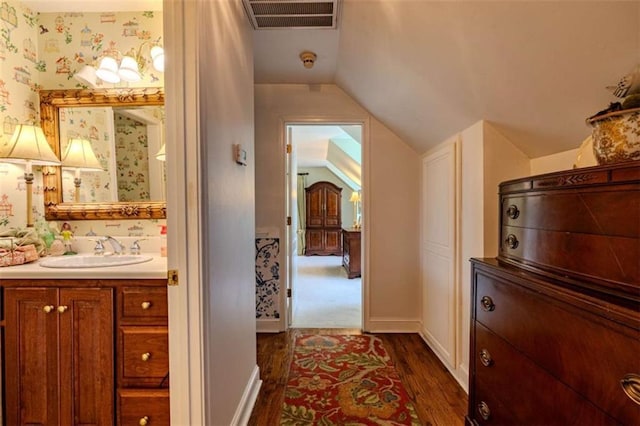 7174 Rockmart Rd, Silver Creek, GA 30173 - hall with a sink, wallpapered walls, dark wood finished floors, visible vents, and lofted ceiling