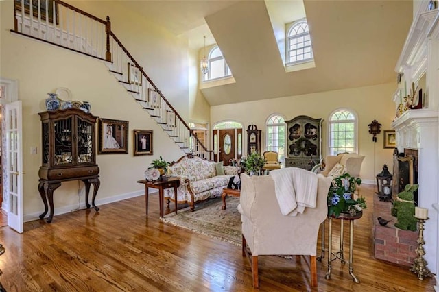 7174 Rockmart Rd, Silver Creek, GA 30173 - living room featuring baseboards, stairway, wood finished floors, and a towering ceiling