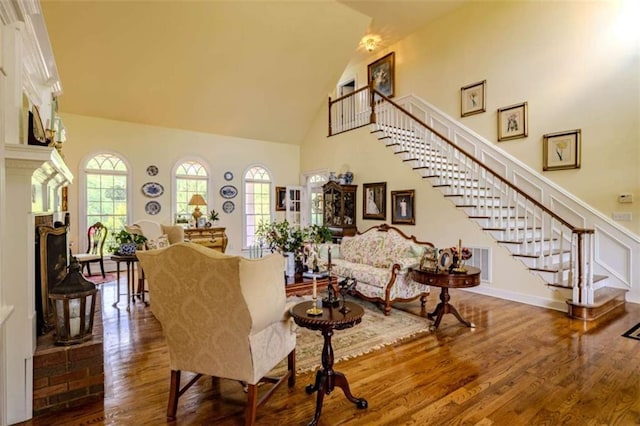 7174 Rockmart Rd, Silver Creek, GA 30173 - living area with stairs, high vaulted ceiling, a healthy amount of sunlight, and wood finished floors