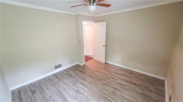 unfurnished bedroom with crown molding, ceiling fan, a closet, and hardwood / wood-style floors