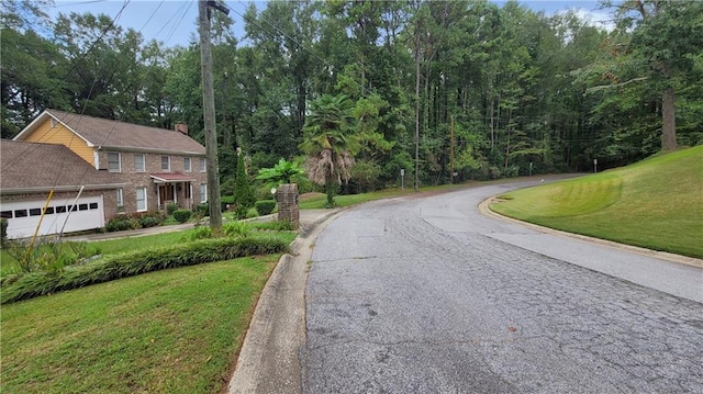 view of front of home with a garage and a front lawn